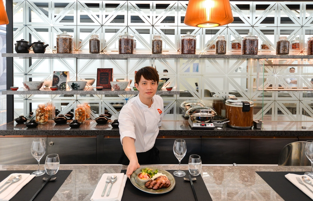 A waiter serving food in an airport lounge of Hong-Kong International Airport