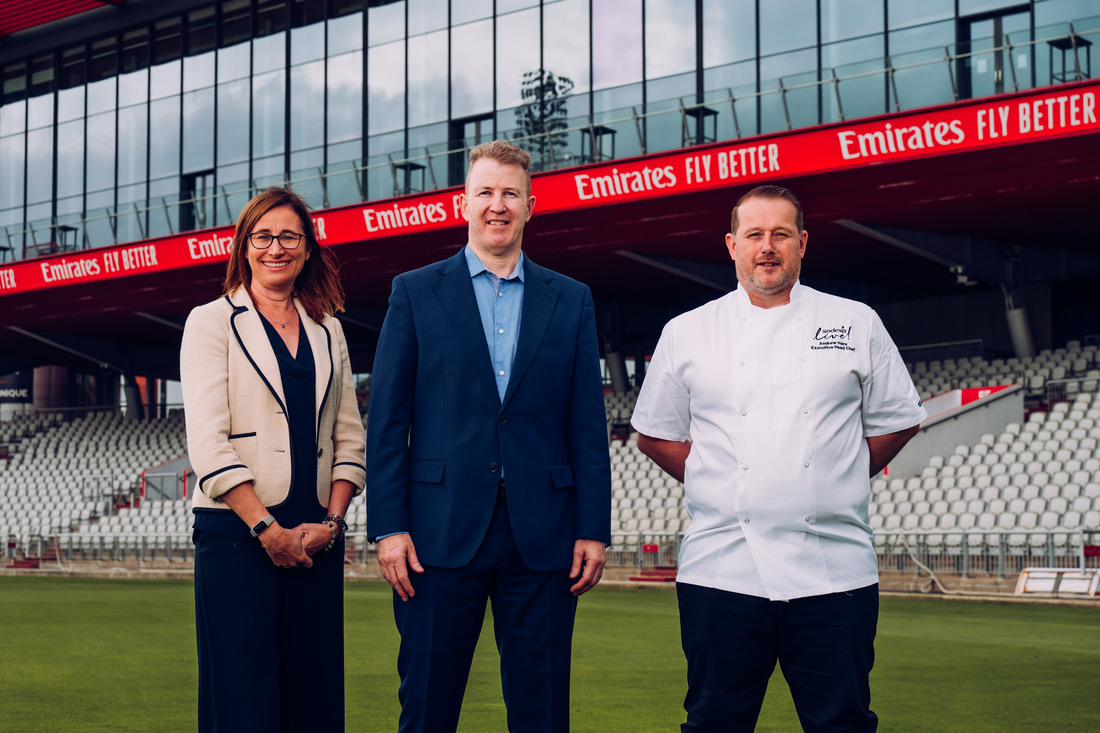 Claire Morris, Daniel Gidney and Andrew Hare on the stadium lawn