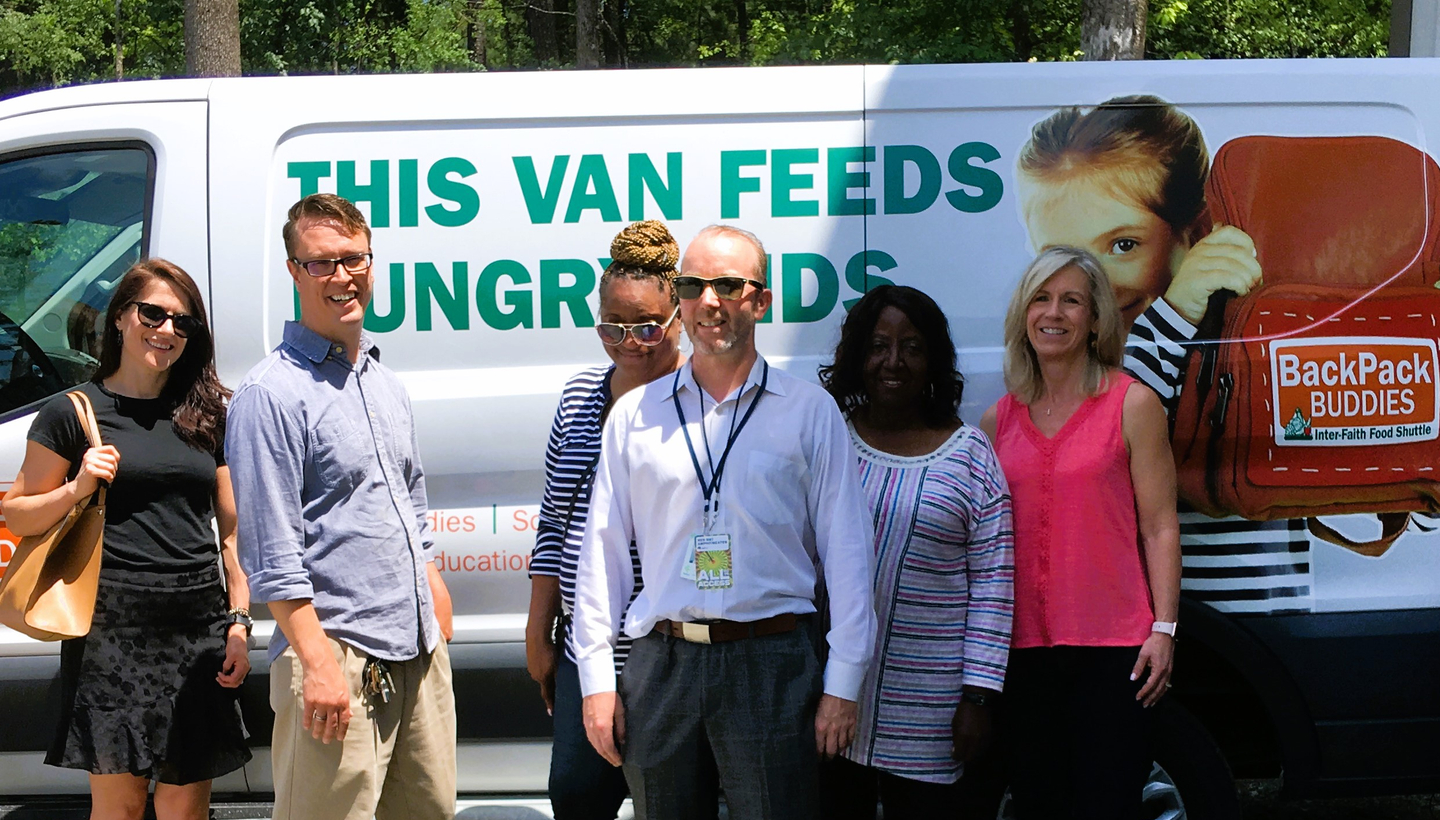 Employees in front of donation van
