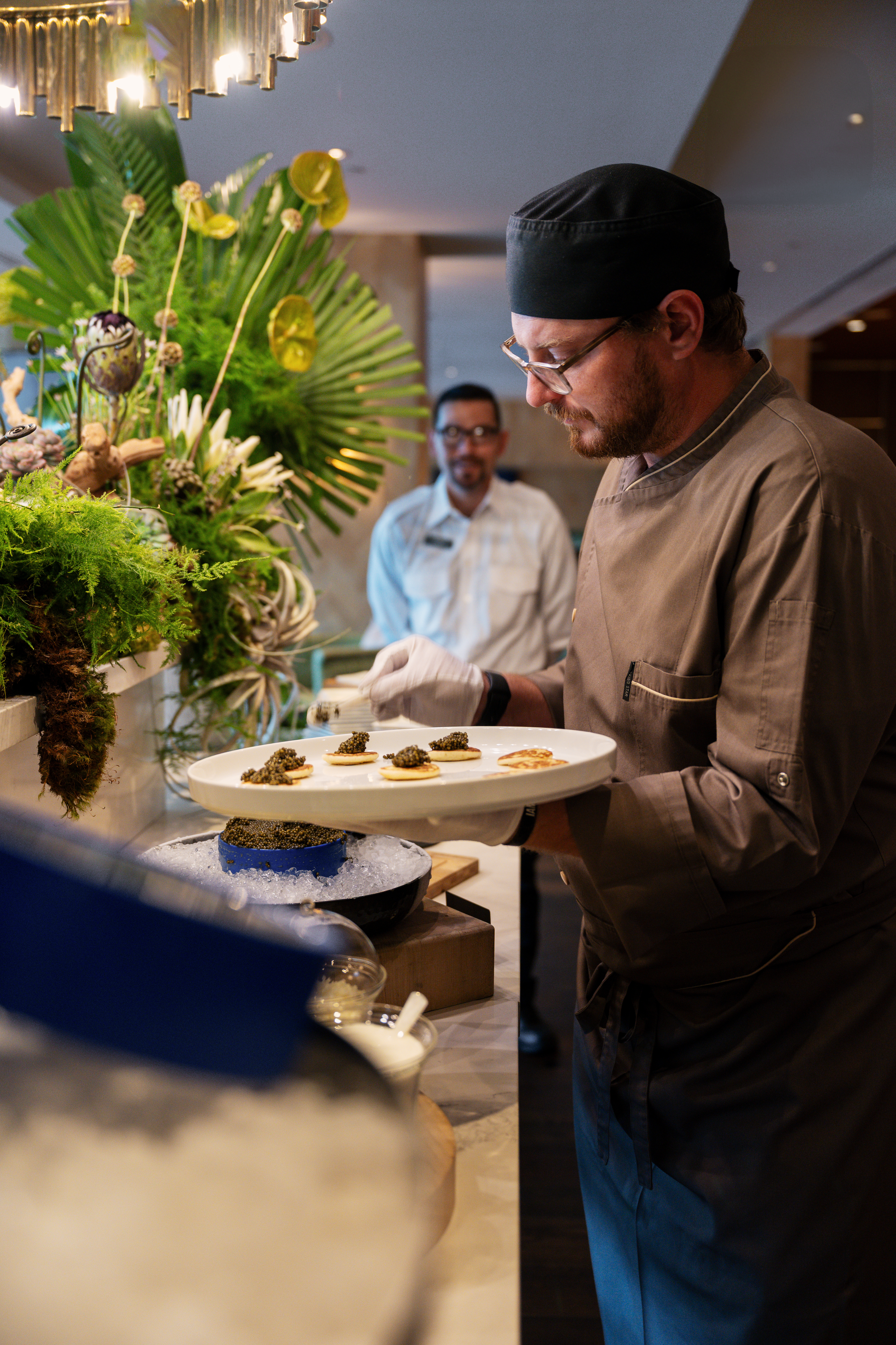 Chef adding items to upscale buffet