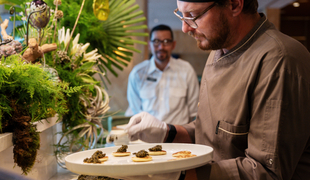 Chef adding items to upscale buffet