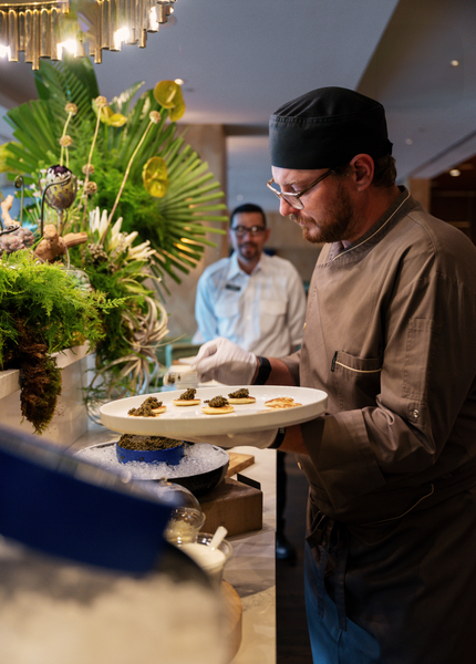Chef adding items to upscale buffet