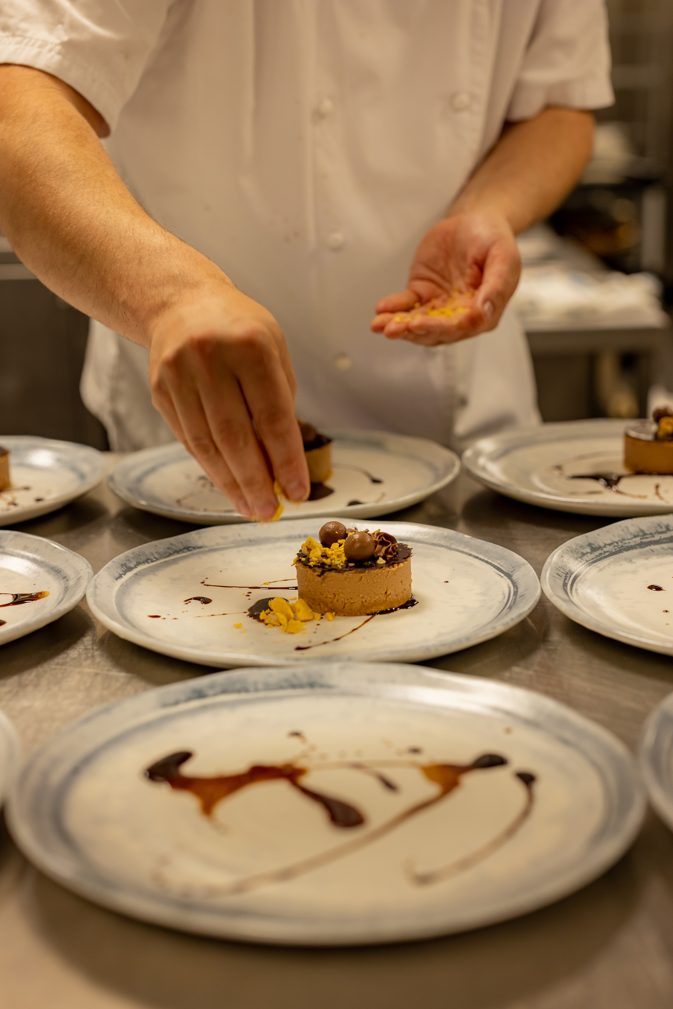 chef plating up a chocolate dessert