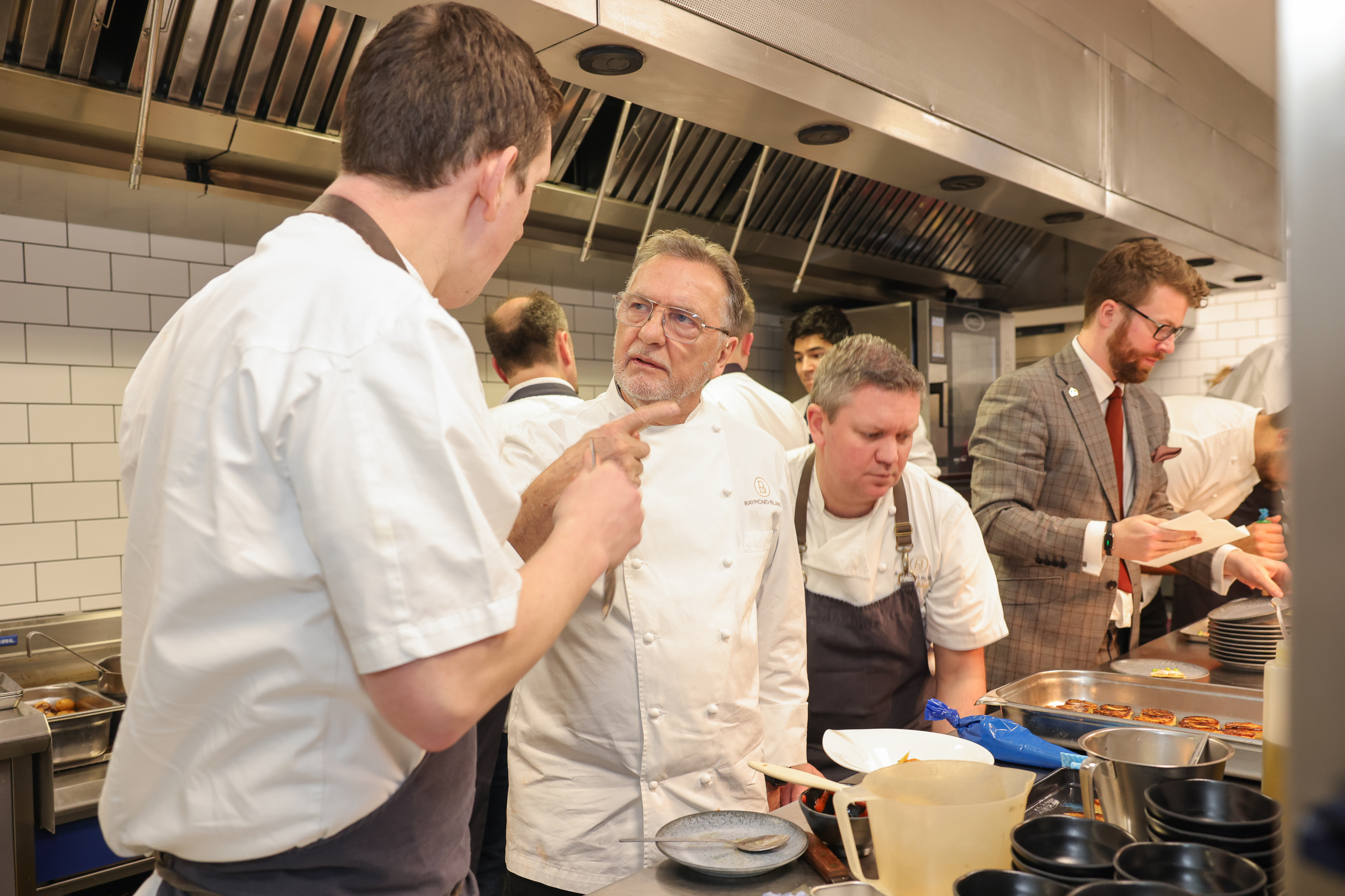 Chefs talking in kitchen