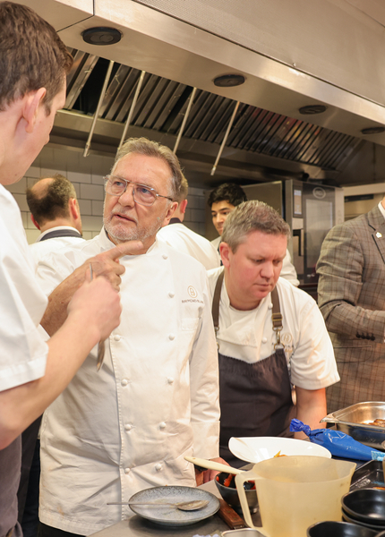 Chefs talking in kitchen